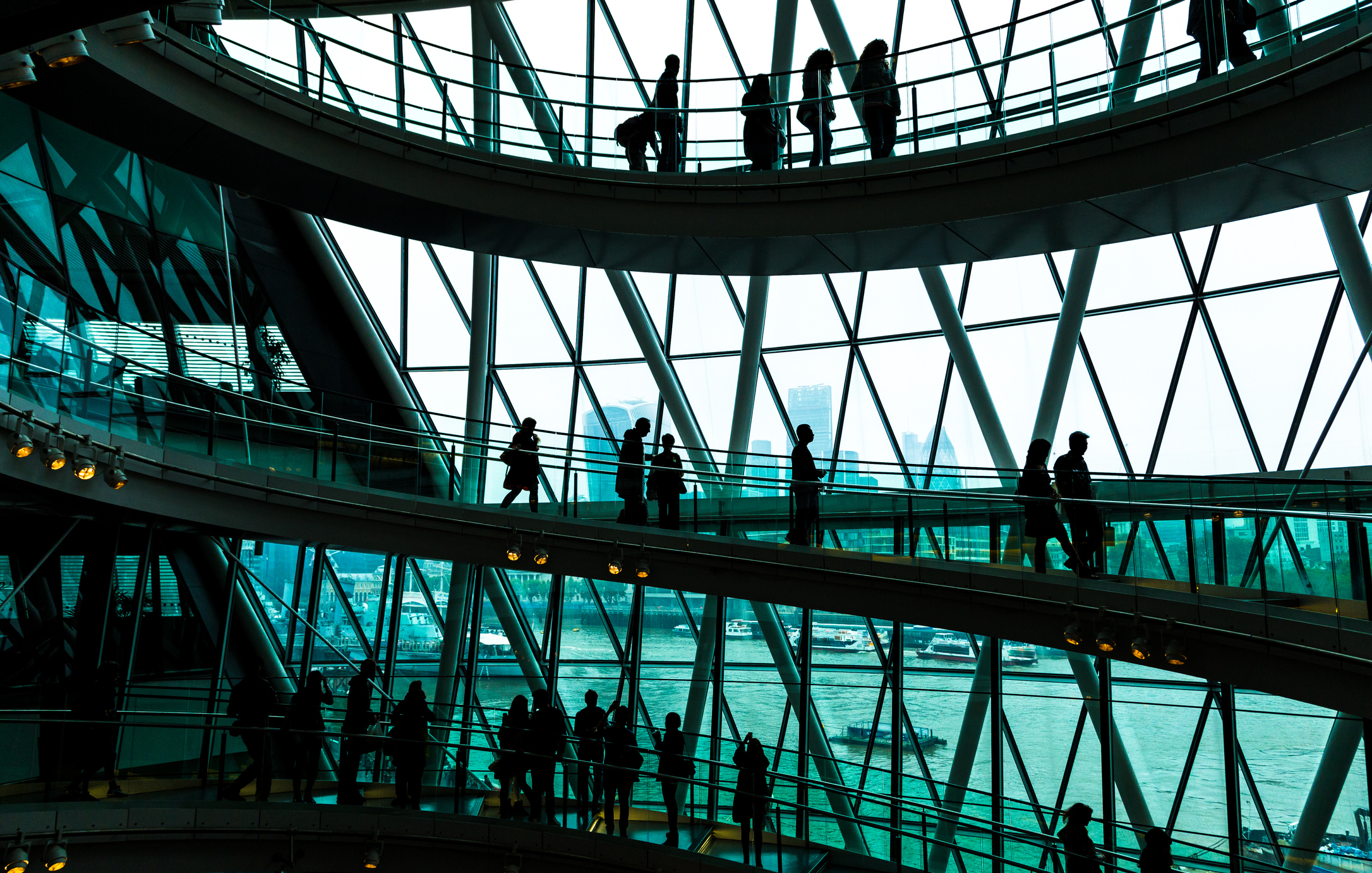 business people on a spiral staircase in a large building