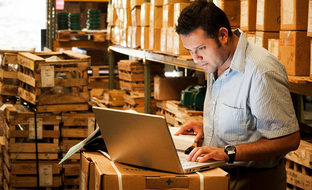 JAGGAER Supply Chain Collaboration - Man in a Warehouse on Computer